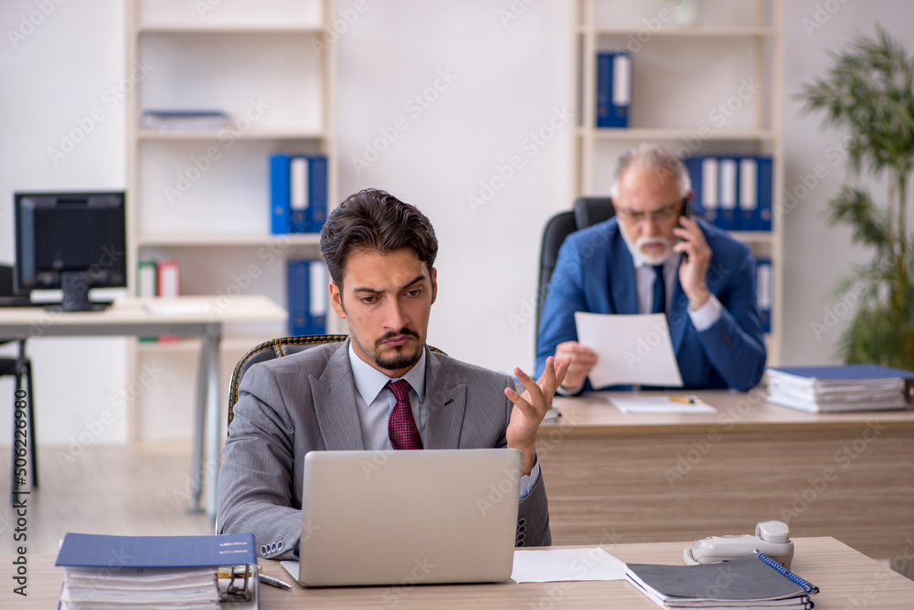 Two male colleagues working in the office Two male colleagues working in the office