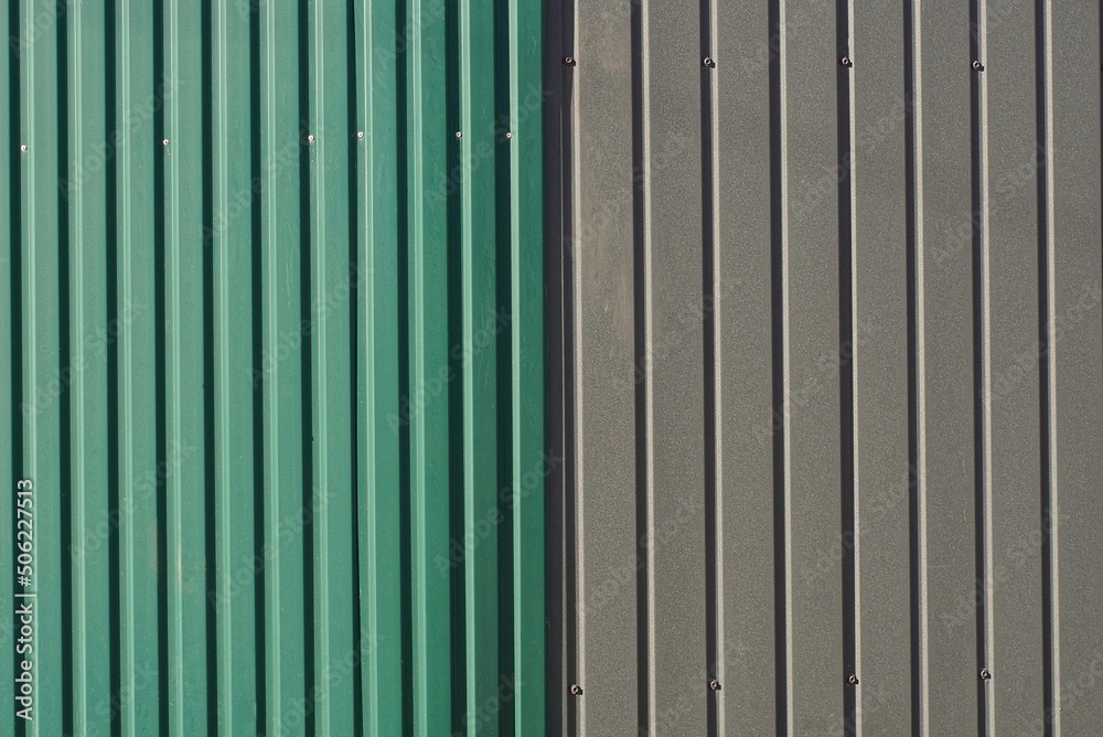 colored texture from a part of a metal gray green wall with striped
