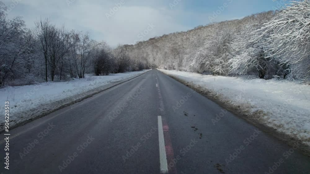 Aerial view of Plateau Lago-Naki mountain twisted road in the winter and driving car. Epic, snowy white winter and snow capped forest. Aerial view of Plateau Lago-Naki mountain twisted road in the winter and driving car. Epic, snowy white winter and snow capped forest.