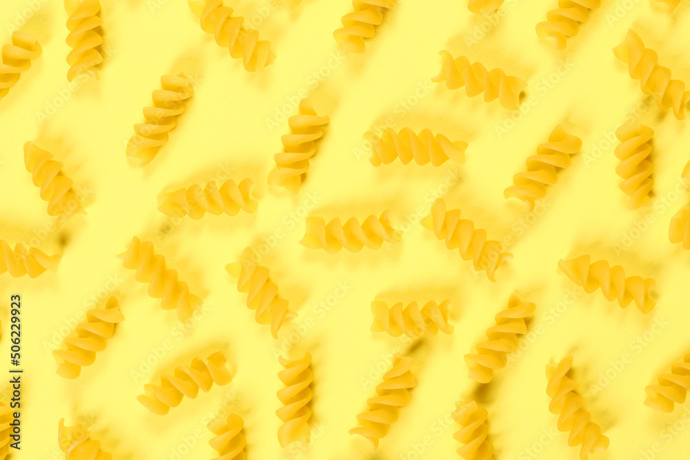 Pasta pattern on yellow background, flat lay, top view 