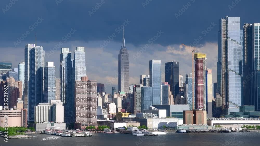 NYC Manhattan skyline, moving clouds and light across the buildings, overcast sky storm clouds over the buildings NYC Manhattan skyline, moving clouds and light across the buildings, overcast sky storm clouds over the buildings