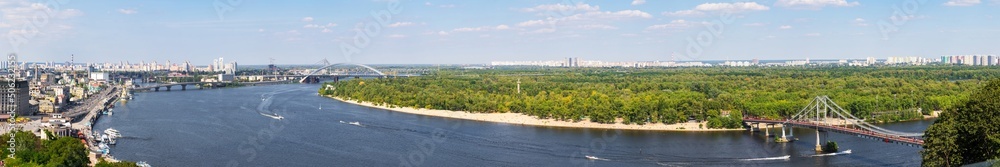 summer panorama of the city of Kyiv, Ukraine, the Dnieper river, bridges across the river and the coastline
