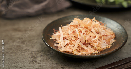 close up Bonito Flakes or katsuobushi on a ceramic plate on a cement background                                              