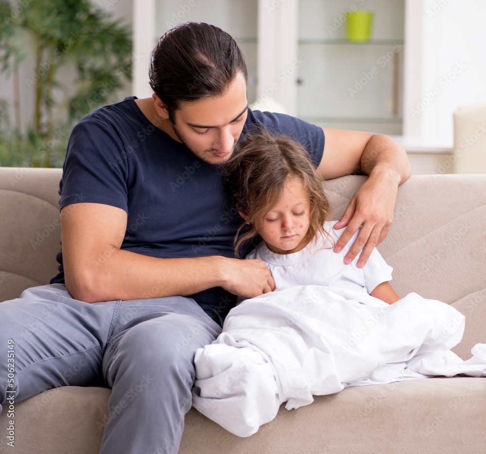 Father taking care of his ill daughter