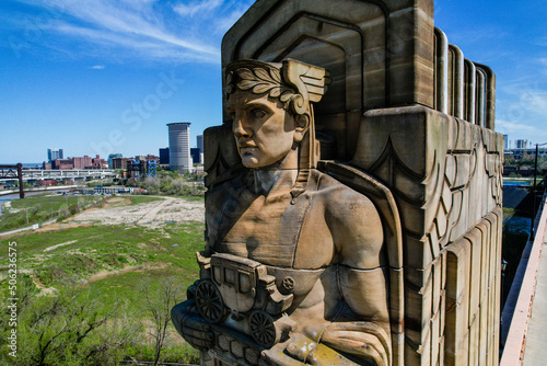 Front side view of one of Cleveland's own Guardians of Traffic Statues facing away from Downtown. This statue holds a carriage and wears a crown made of Laurel leaves.