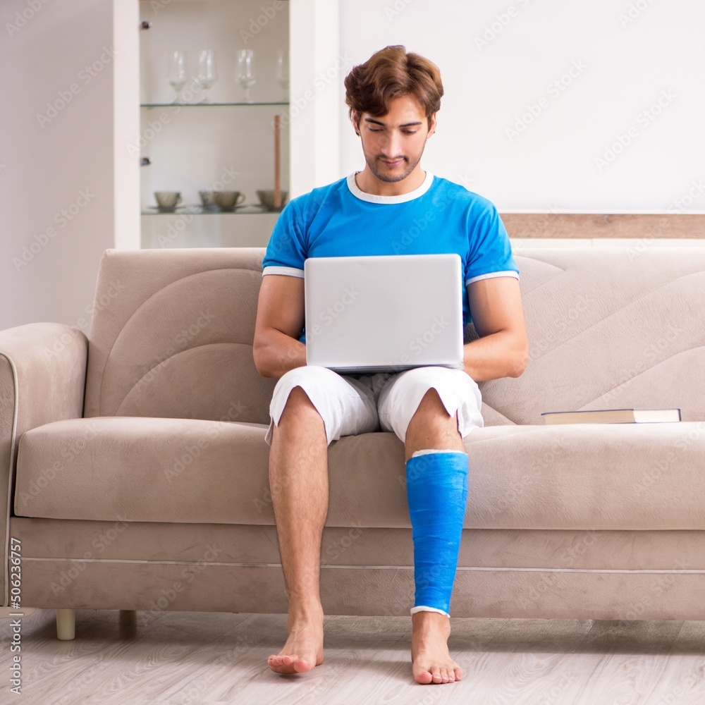 Leg injured young man on the sofa Leg injured young man on the sofa