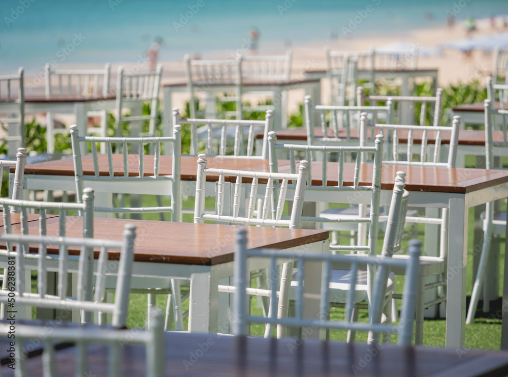 Large beach cafe with tables and chairs placed at the sea waterfront