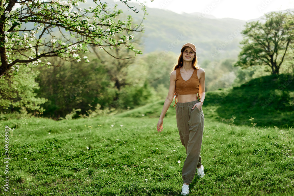 A woman walks in the park and does yoga and enjoys the fresh summer air. Lifestyle and mind and body health care A woman walks in the park and does yoga and enjoys the fresh summer air. Lifestyle and mind and body health care