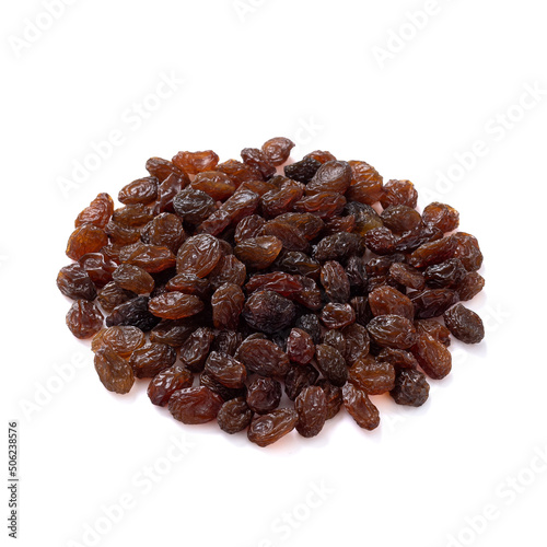 a pile of dark raisins lies isolated on a white background