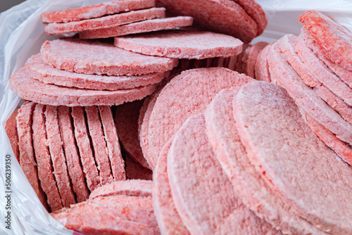 Frozen hamburger beef patties. Semi-finished products for fast-food.