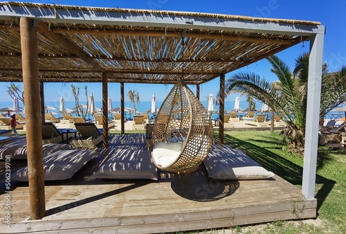 sea beach bar umbrellas and chairs by sand in preveza, monolithi beach greece photo