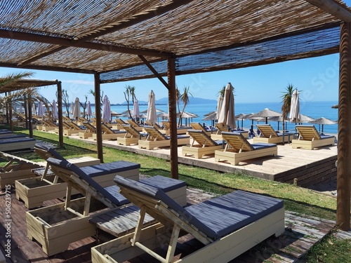 sea beach bar umbrellas and chairs by sand in preveza, monolithi beach greece photo