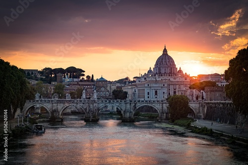 Sunset view of old Sant  Angelo Bridge and St. Peter s cathedral in Vatican City  Rome.Italy
