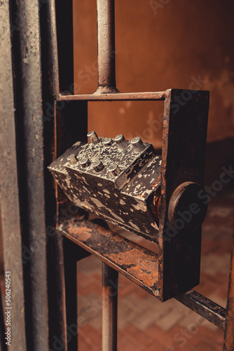 Old combination lock on an iron gate, photo in the afternoon