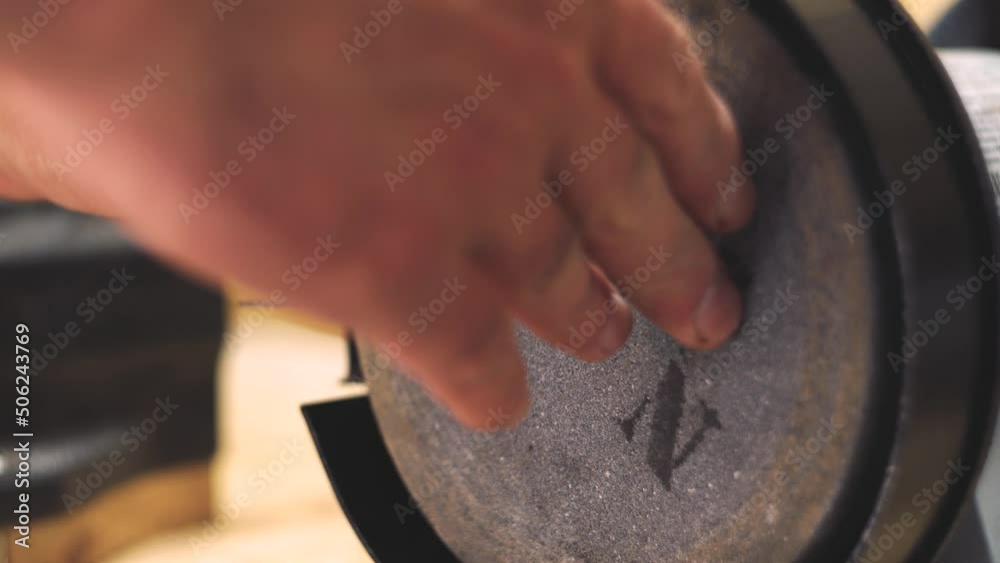 Assembly of the grinder. Grinding machine. Work in the workshop. Production. Metalworking. Man's hands. Close-up.