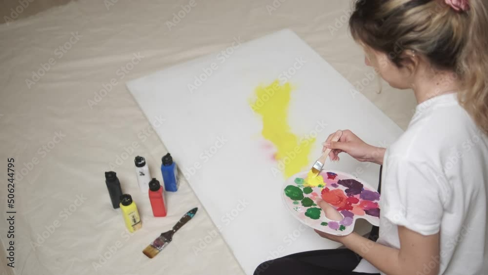 modern woman painting on canvas on plain background, studio shot modern woman painting on canvas on plain background, studio shot