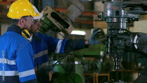 Engineer teach leader worker to use milling machine and preventive maintenance method in the industrial manufacturing factory.