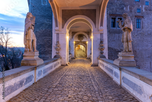 Vew of the covered bridge with statues in Cesky Krumlov castle in the sunrise. Czech Republic. © frank11