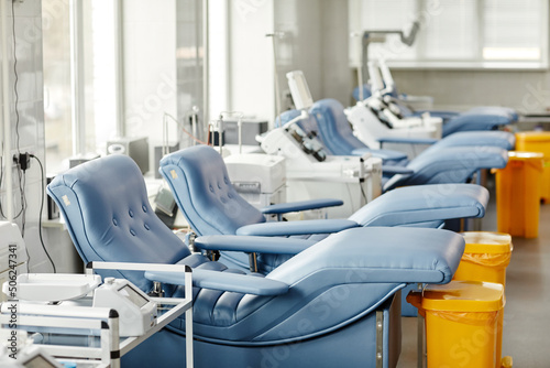 Background image of med chairs in row at modern blood donation center, copy space