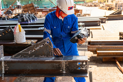 Inspectors are checking defects in welded steel h-beam add joint with process Ultrasonic testing (UT) of Non-Destructive Testing(NDT)