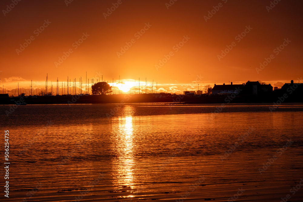 sun setting over the sea with Langstone bridge in the background	