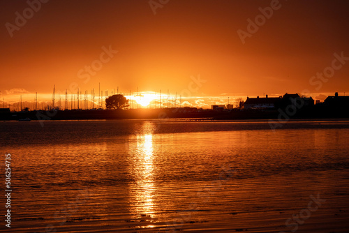 sun setting over the sea with Langstone bridge in the background 