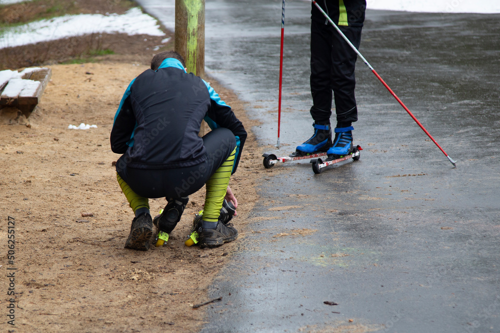 A man rides roller skis in a winter park. The beginning of winter. A man rides roller skis in a winter park. The beginning of winter.