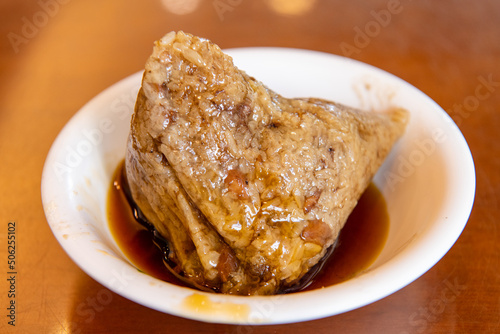rice dumpling is a traditional Chinese rice dish made of glutinous rice and wrapped in bamboo leaves,