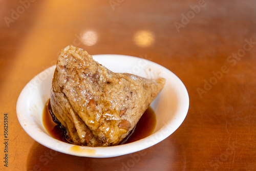 rice dumpling is a traditional Chinese rice dish made of glutinous rice and wrapped in bamboo leaves,
