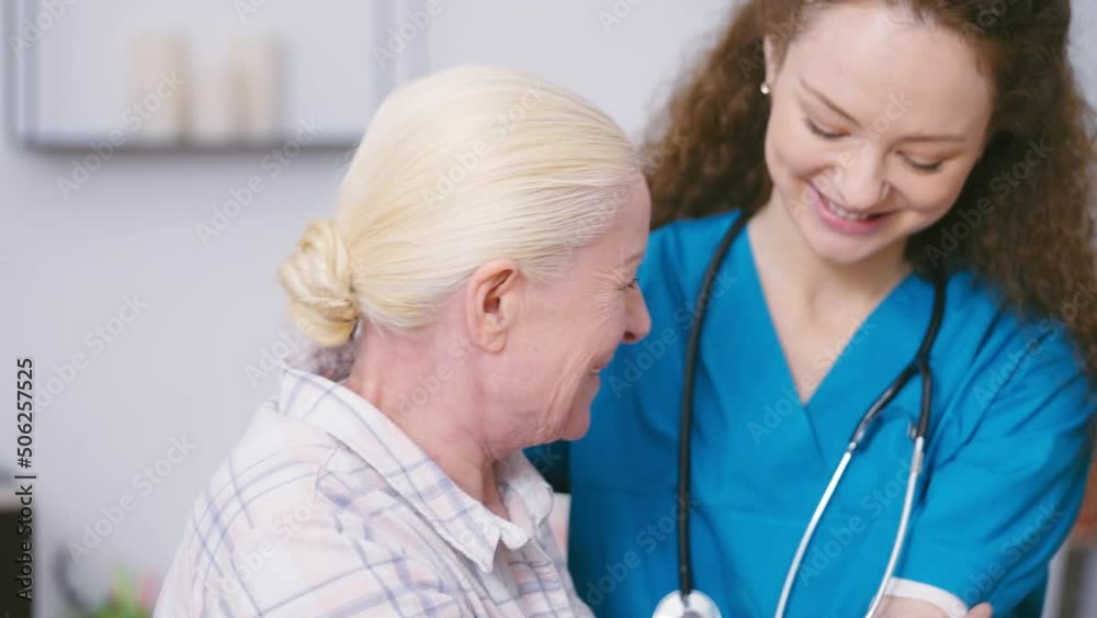 Home nurse helping senior woman to stand up and take a walk, elderly care Home nurse helping senior woman to stand up and take a walk, elderly care