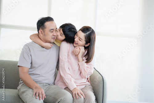 Happy Asian family with son playing at home and everyone having fun together at home.
