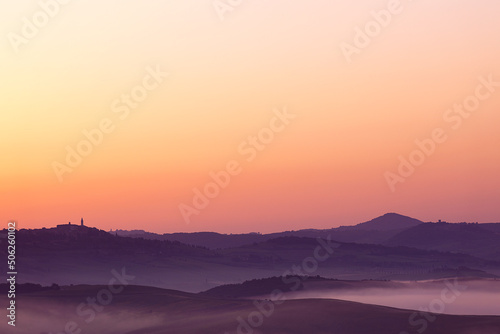 Sunrise with fog over a valley in Tuscany - Italy III