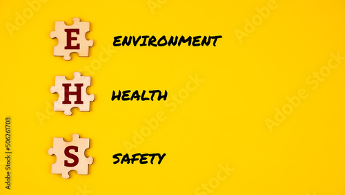 Jigsaw puzzle with alphabet  EHS  isolated with yellow background. EHS  environment  health  safety .