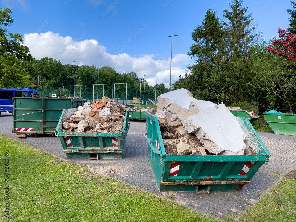 in some large containers there is the waste from a house demolition