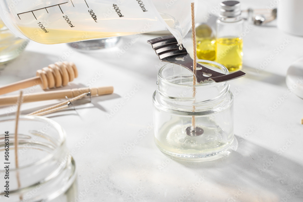 Set tools for homemade natural eco-friendly soy wax candles, wick, perfume, essential oil on a marble table. Making process. Trendy DIY. Craft hobby, small business, artisan products concept Set tools for homemade natural eco-friendly soy wax candles, wick, perfume, essential oil on a marble table. Making process. Trendy DIY. Craft hobby, small business, artisan products concept