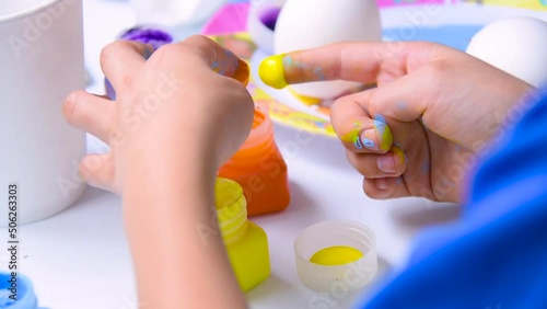 Children's craft made with eggshells painted with tempera, multi color school homework, primary school homework easter celebration.