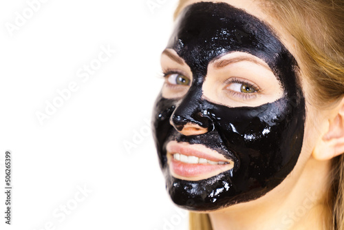 Woman with black peel off mask on face