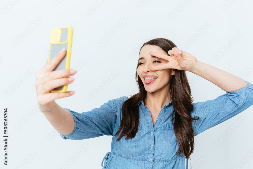 Cheerful young brunette woman taking selfie Cheerful young brunette woman taking selfie