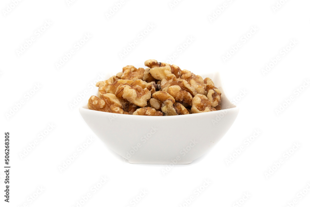 A white bowl with nuts. Isolated on white background. Nuts are available in two forms, shell or shelled, and can be whole, halved, or in smaller portions due to processing. 
