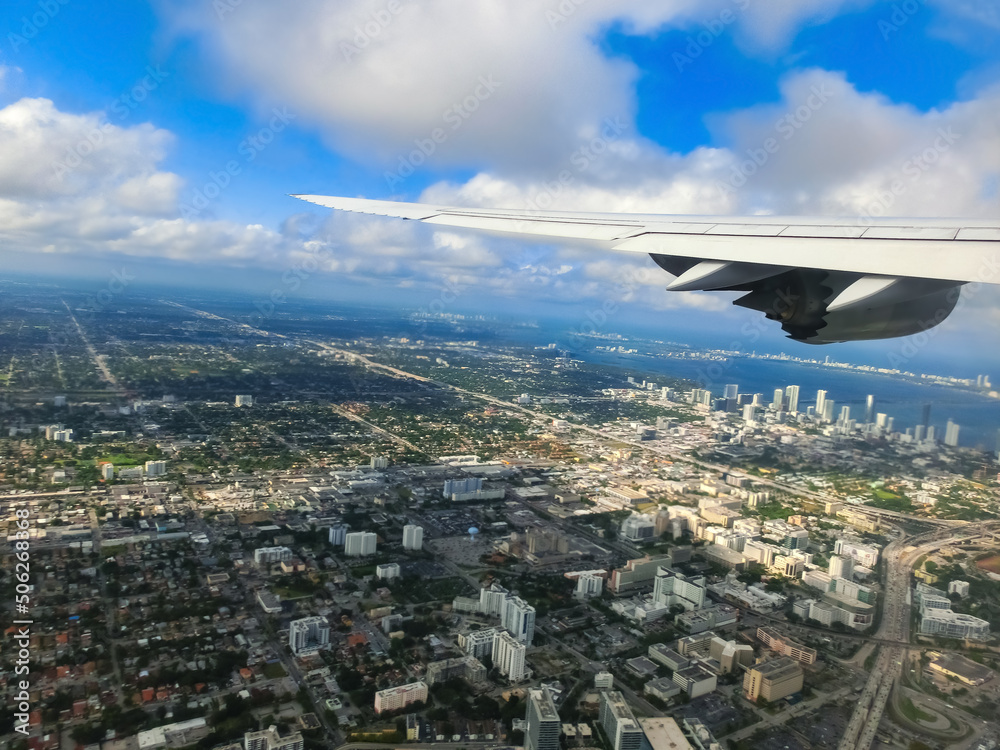 Miami from airplane porthole at day with blue sky Miami from airplane porthole at day with blue sky