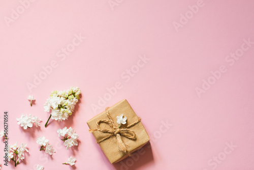 lilac flowers with eco gift box from kraft paper. Creative congratulations layout. Spring flower concept. © Ivanna Pavliuk