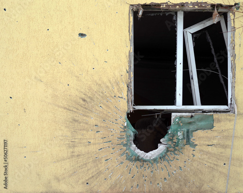 Hole in the wall of the house from the shell of the Russian army. War in Ukraine. photo