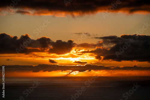 Picturesque seascape with a very beautiful sunset and illuminated clouds over the Atlantic Ocean at the west coast of Madeira  seen from Ponta do Pargo lighthouse