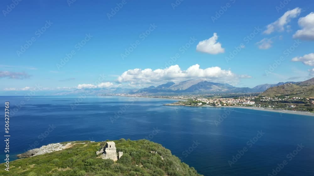 The island Isola di Cirella in the Tyrrhenian Sea in front of the arid mountains in Europe, Italy, Calabria, in summer on a sunny day. The island Isola di Cirella in the Tyrrhenian Sea in front of the arid mountains in Europe, Italy, Calabria, in summer on a sunny day.