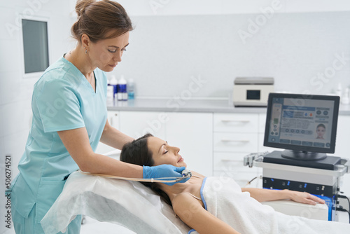 Woman receiving facial skincare treatment in beauty salon