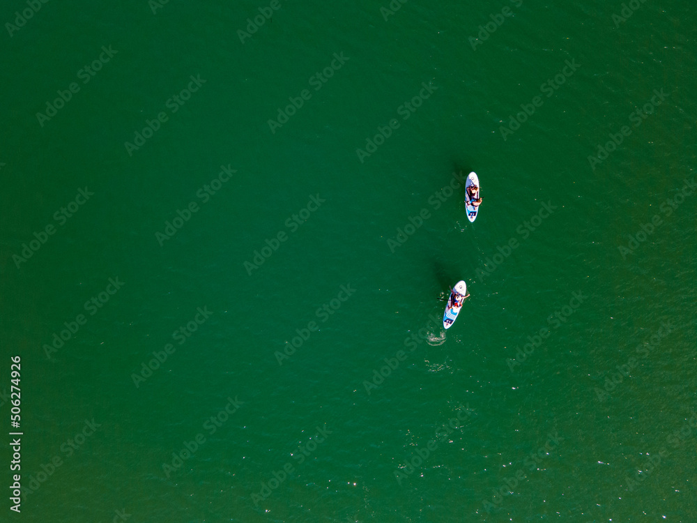 overhead view of people on paddle boards in the middle of the lake
