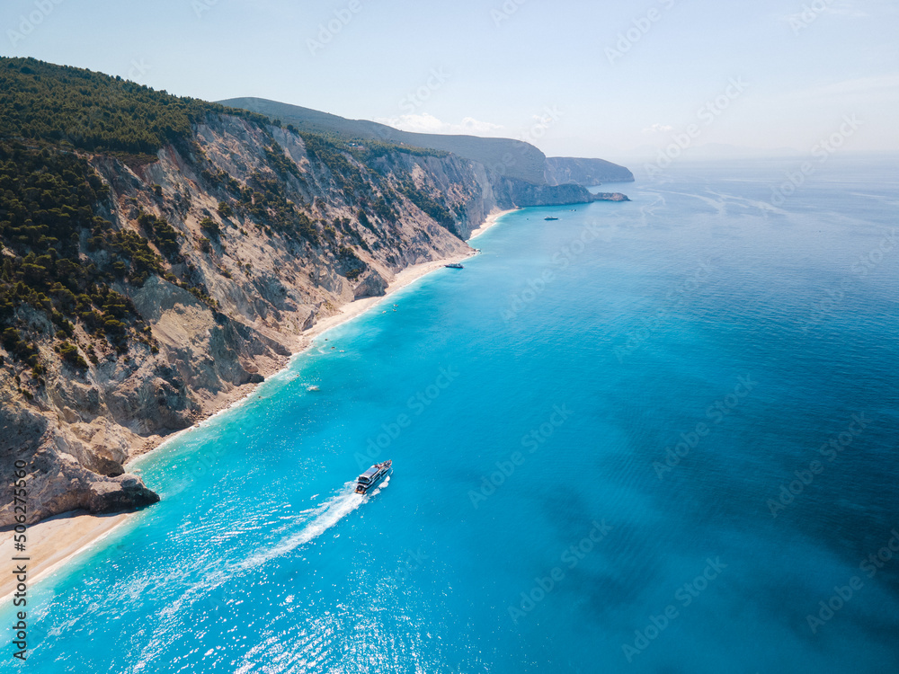 aerial view of small cruise boat sailing around Lefkada island