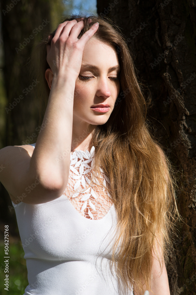 Beautiful lonely young woman is sad walking in nature.