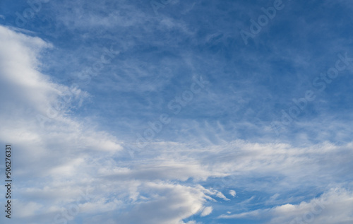 Blue sky with white clouds in sunlight, wide cloudscape background © wildman