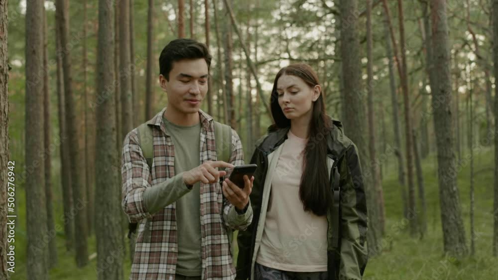 Young couple hiking in a forest Young couple hiking in a forest